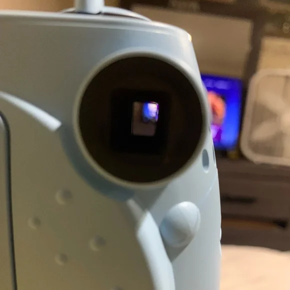 Light blue Polaroid camera and matching photo book to them the memories in.